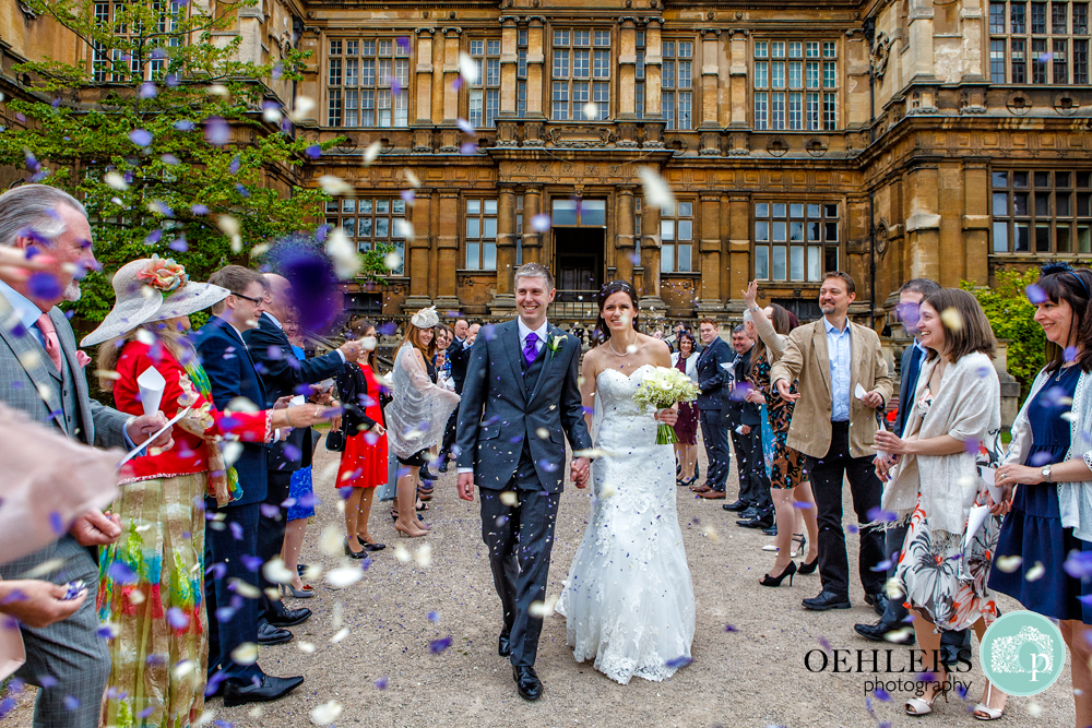 guests throwing confetti at Wollaton Hall
