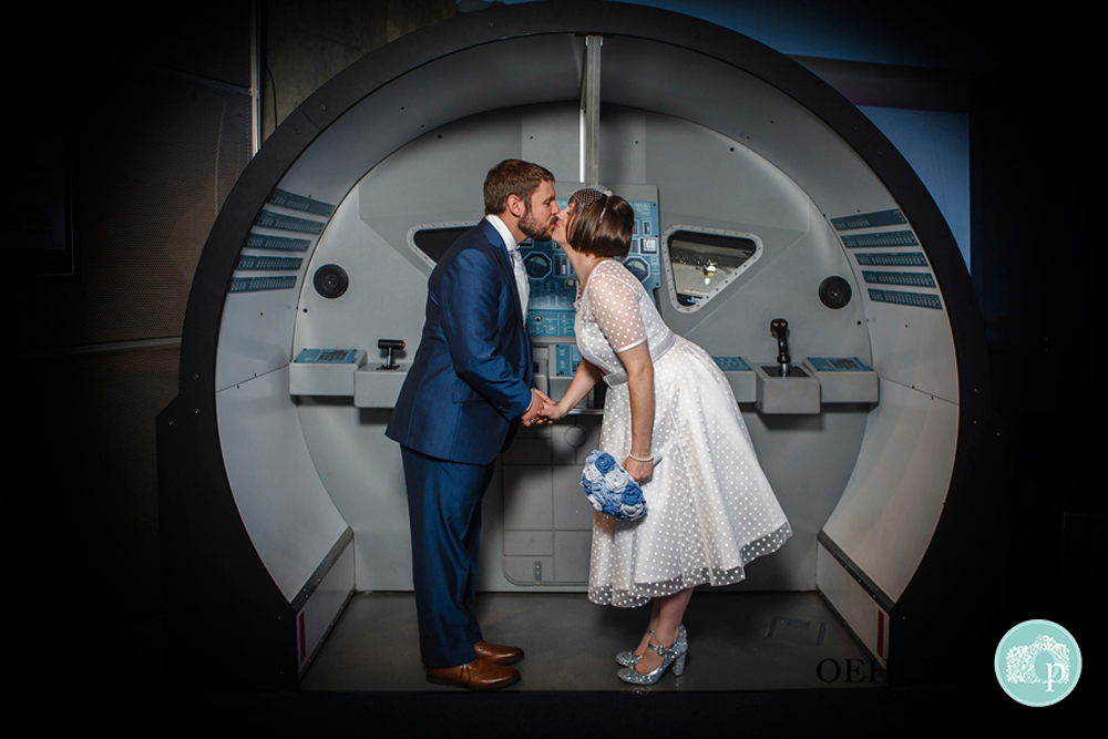 Bride and Groom stealing a kiss in the Space Centre