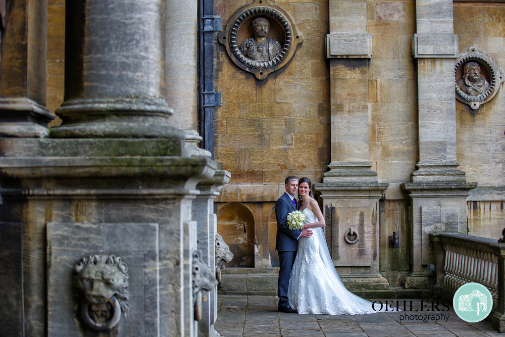 Bride and Groom pose in front of Wollaton Hall