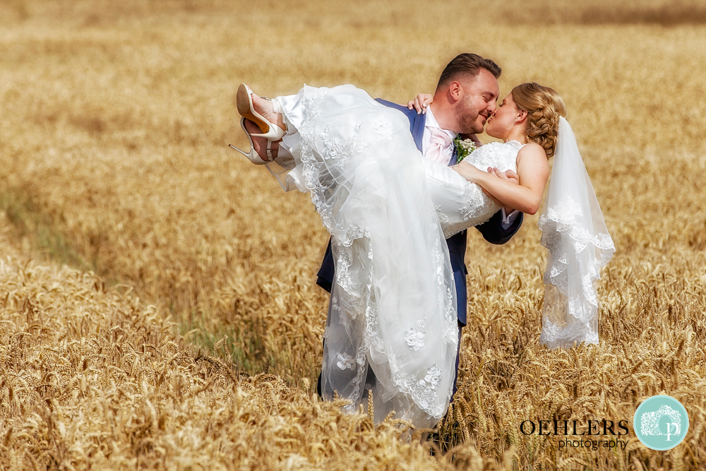 Groom swept Bride up in a corn field