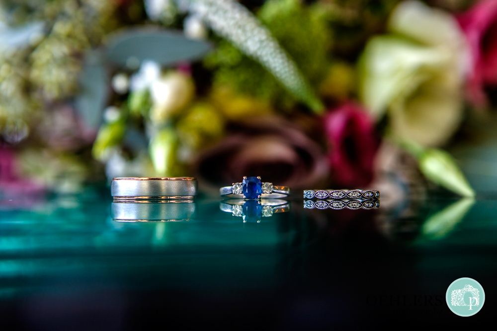 Wedding rings and sapphire engagement ring in the middle
