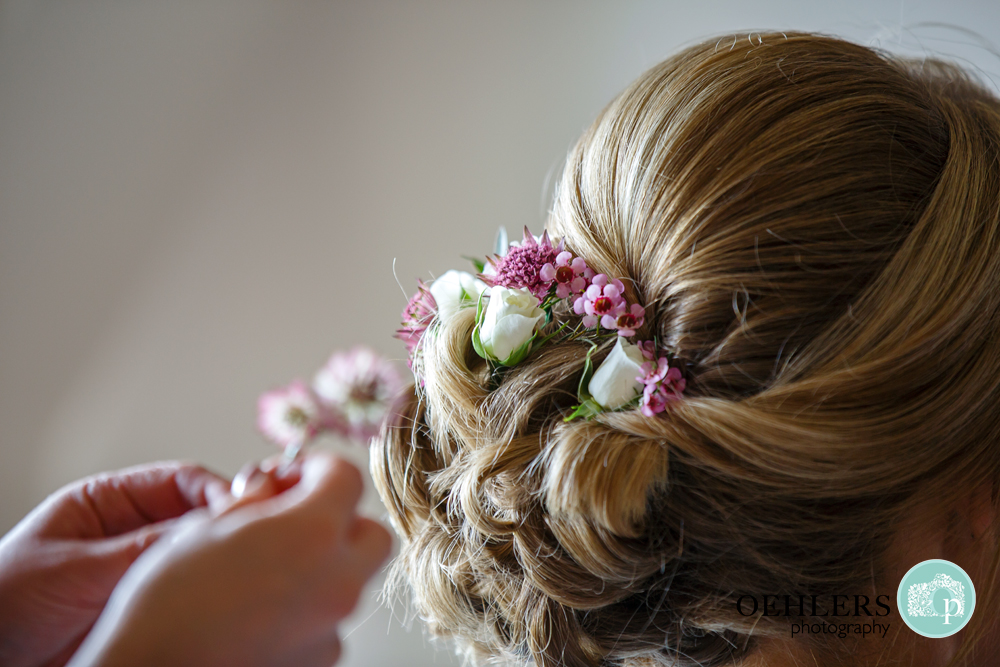 Lovely delicate flowers in the bun of the bridesmaids hair