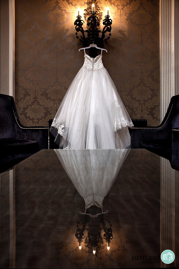 wedding dress hanging up with reflection