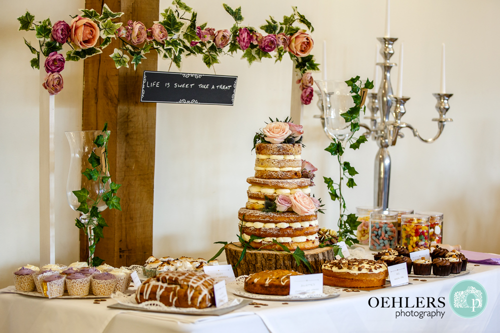 table full of delicious cakes including the wedding cake