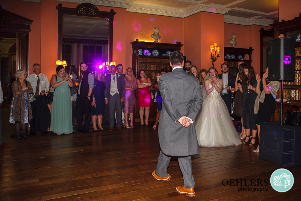 Groom doing a jig in front of his Bride