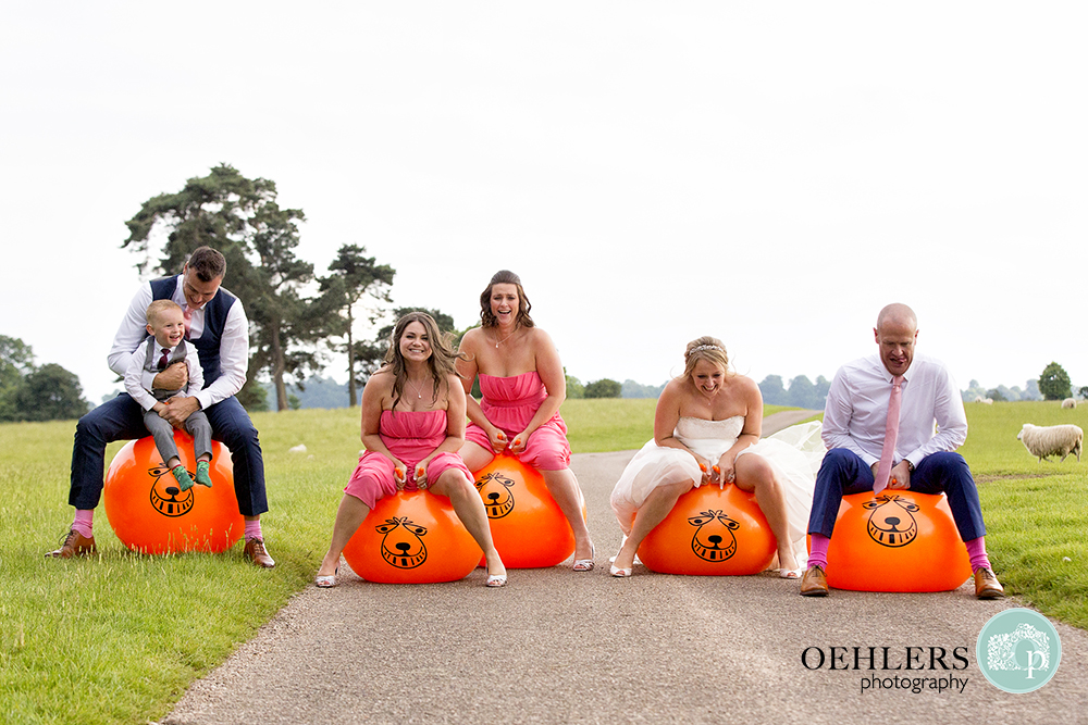 Bride and Groom and guests on space hoppers having a race