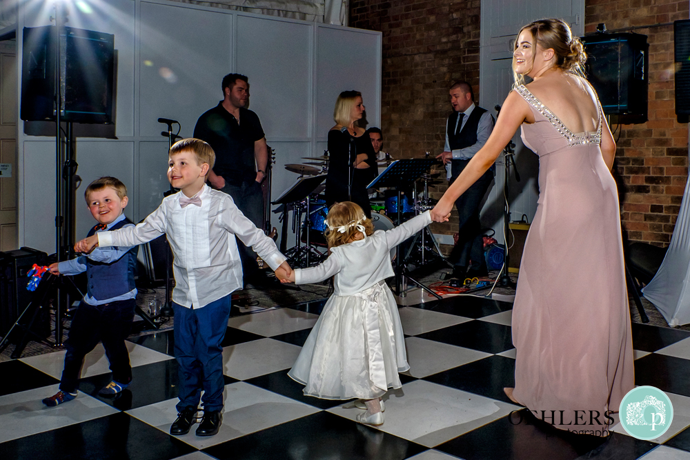 Bridesmaids dancing with the flowergirl