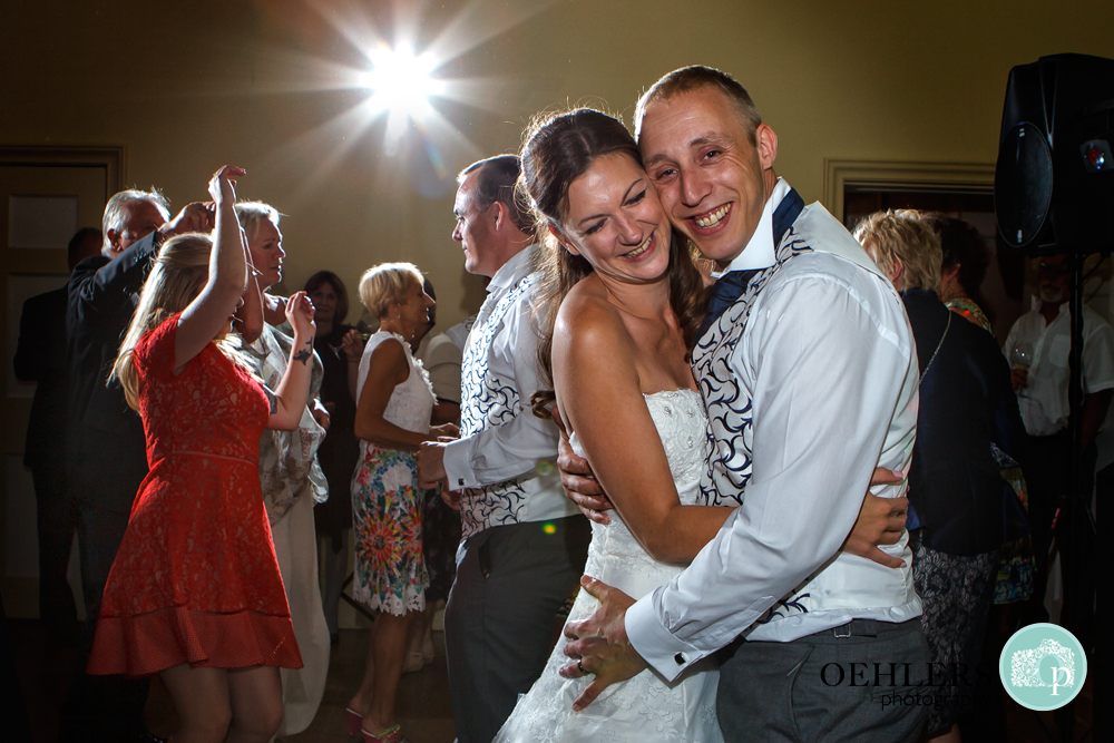 Bride and Groom snuggle together for their dance