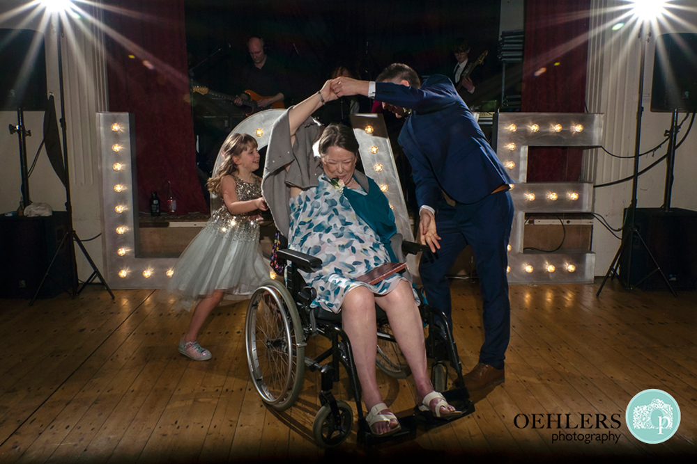 On the dance floor dancing with mum in a wheelchair