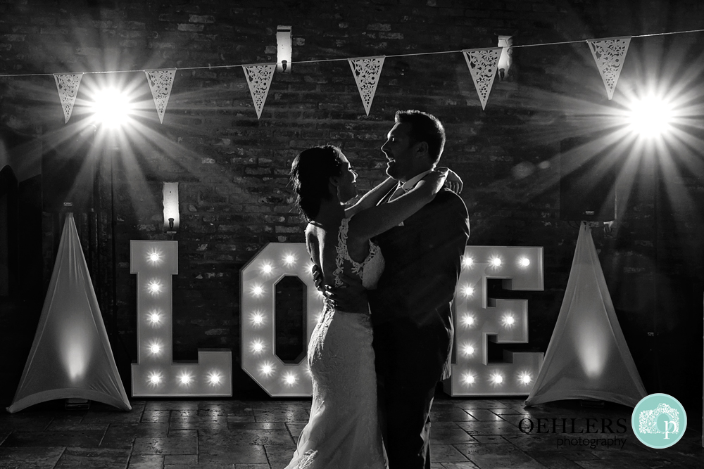 First Dance with Love sign and starbursts in the background