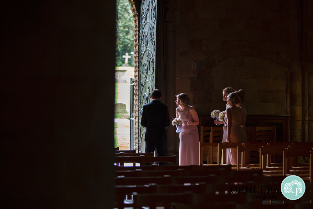 bridesmaid wait for their bride at Southwell Minsters doorway