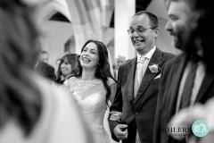 happy bride and dad walking down the aisle