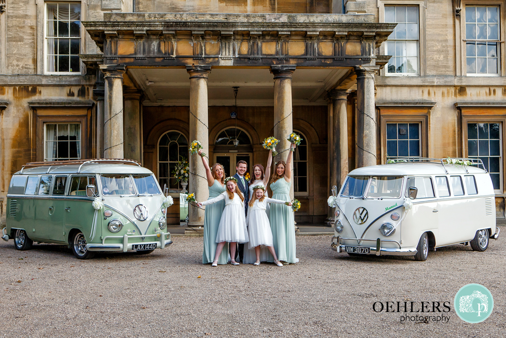 Bridal party outside Preswold Hall in between two camper vans.