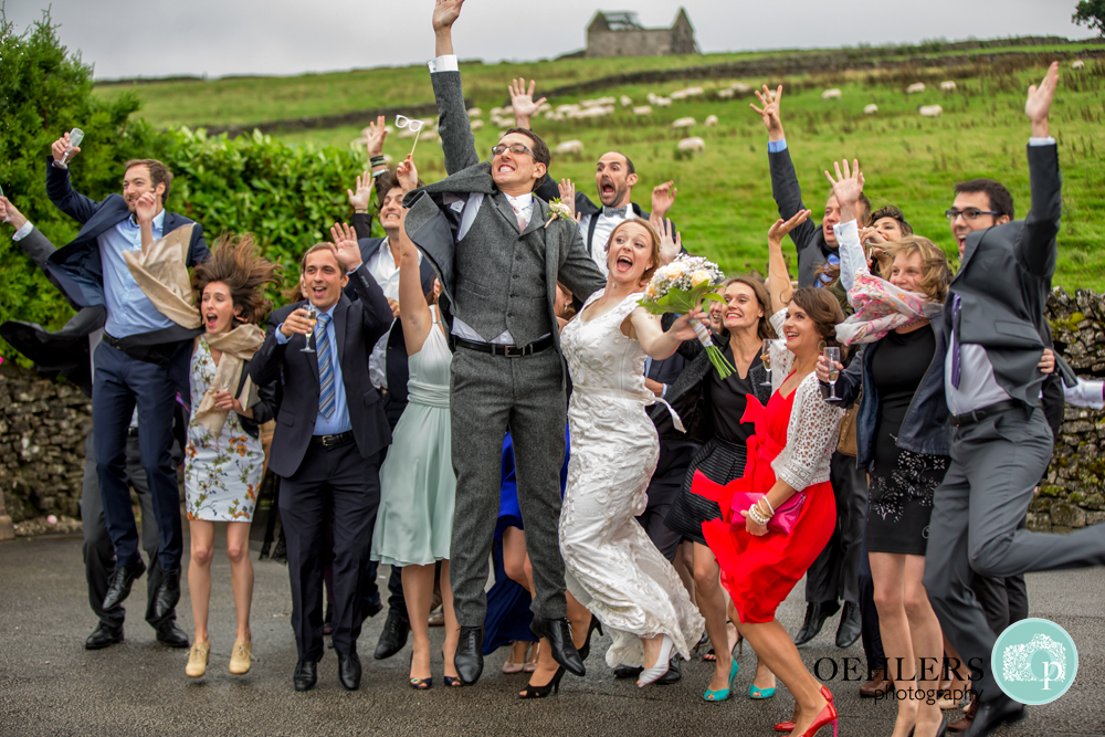Group Shot of Bridae and Groom's friends jumping for joy.