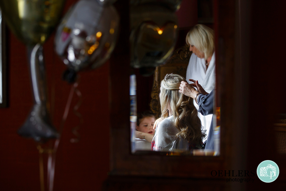 reflection of bride getting ready in the mirror