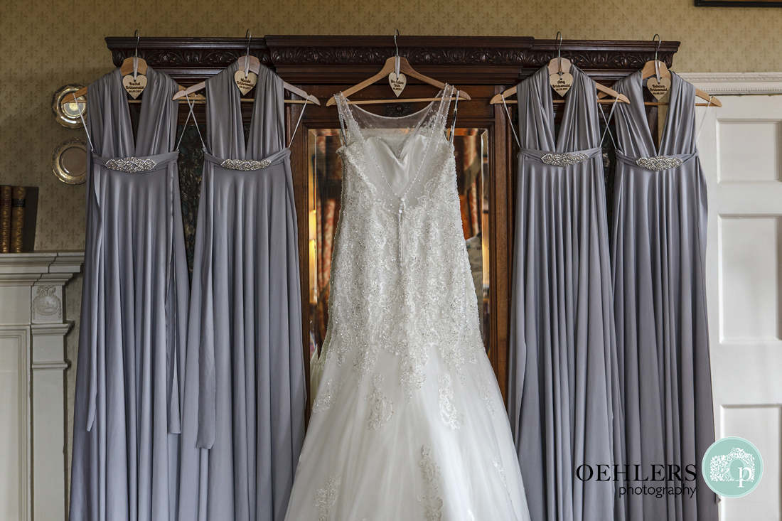 Wedding dress pale blue bridesmaid dresses hangin on a wardrobe.