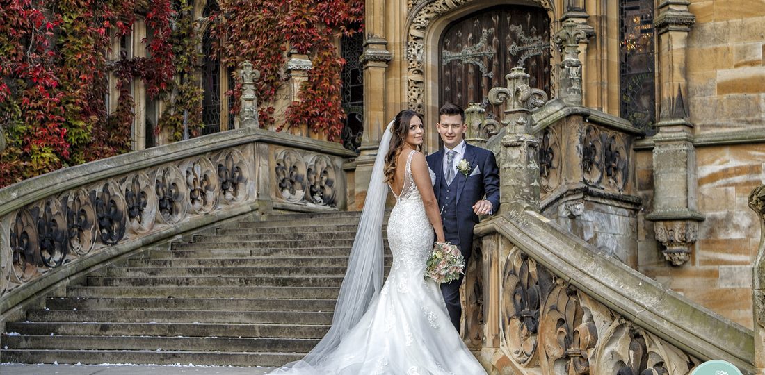 Bride and groom on magnificent staircase at Carlton Towers