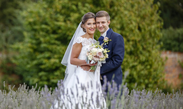 Bride and groom behind lavender