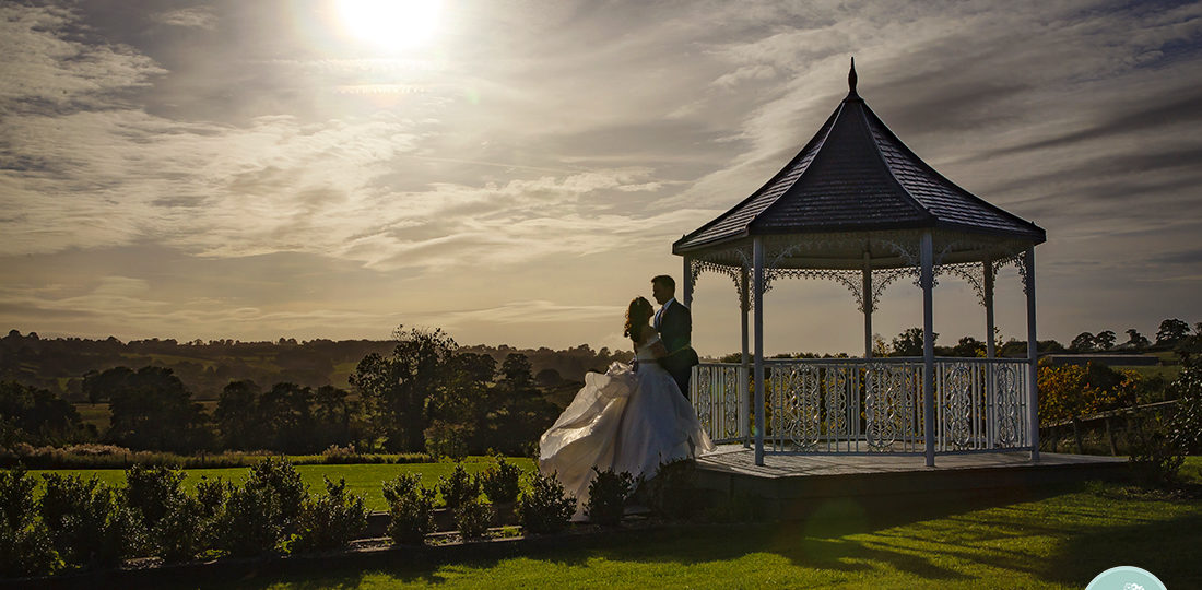 Romantic silhouette of the Bride and Groom at the gazebo