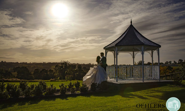 Romantic silhouette of the Bride and Groom at the gazebo