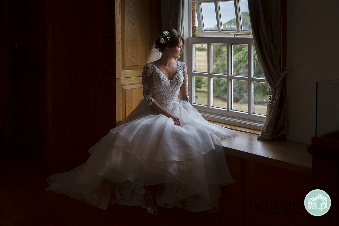 Portrait of the bride looking out of the window