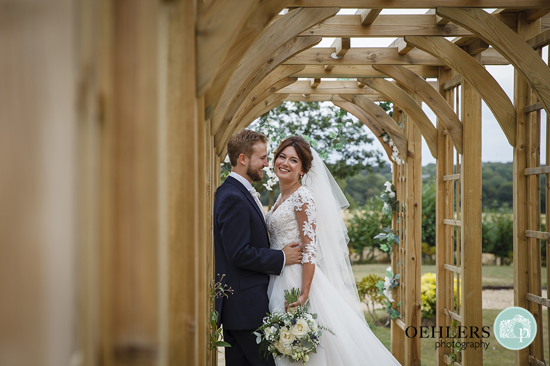 Bride and Groom under an arbour