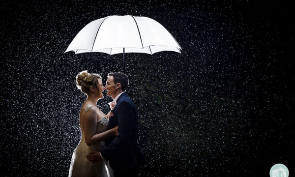 bride and groom in the rain