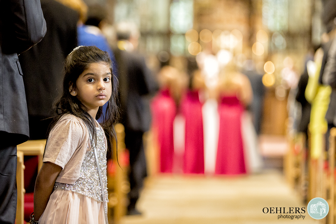 Photograph capturing a young guest looking at the camera in the aisle.