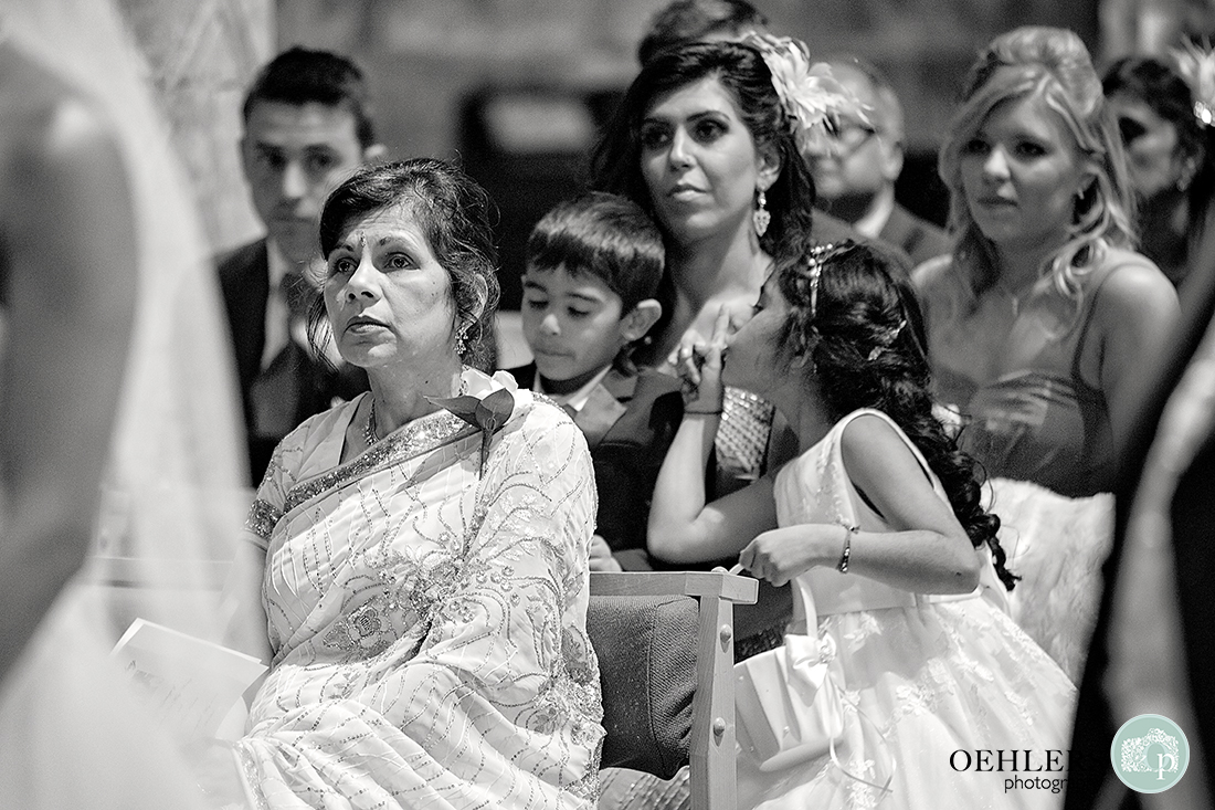 Black and White Photograph of the congregation with young flowergirl telling her brother to keep quiet.