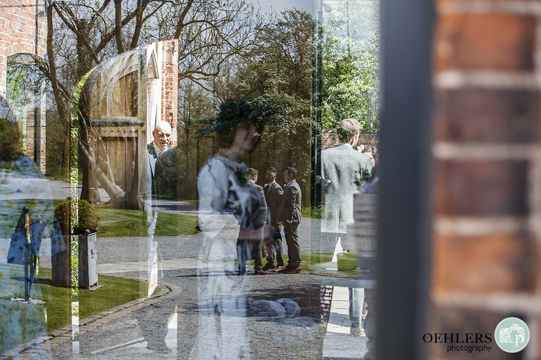 Complex reflection of guests in the courtyard and entrance hall.