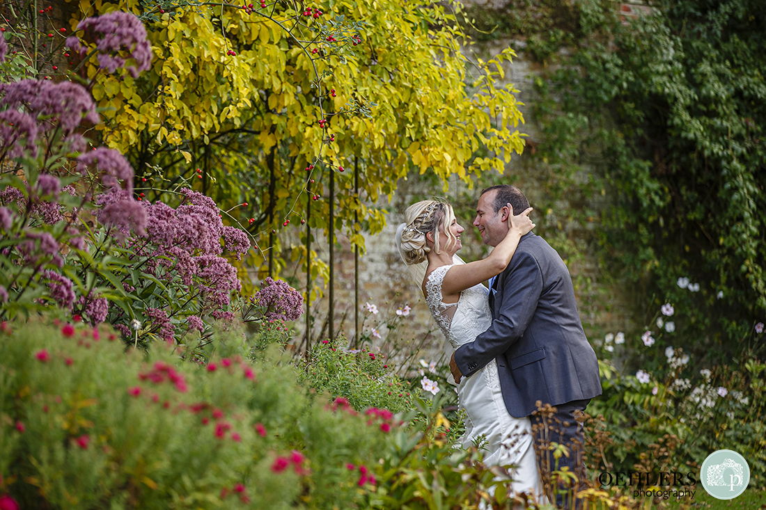 bride and groom stealing a moment together in the gardens at Calke Abbey