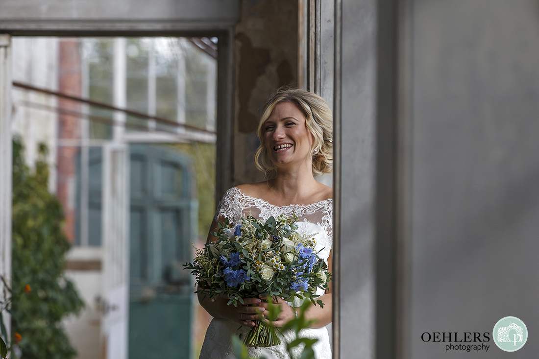 bride laughing gorgeously at the grrom who is out of the picture