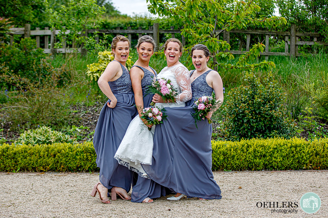 Kedleston Country House Photographers - bride and bridesmaids striking a pose.
