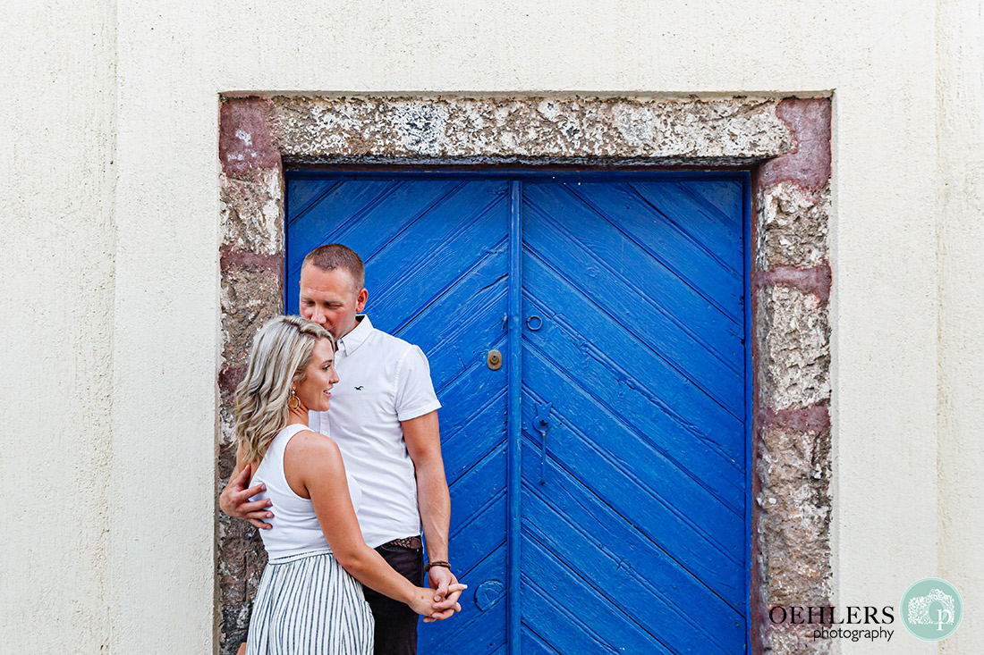 Couple in front of a Blue Door.