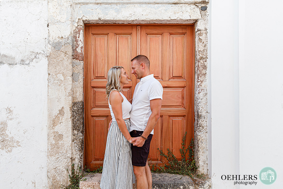 Couple in front of a wooden door.