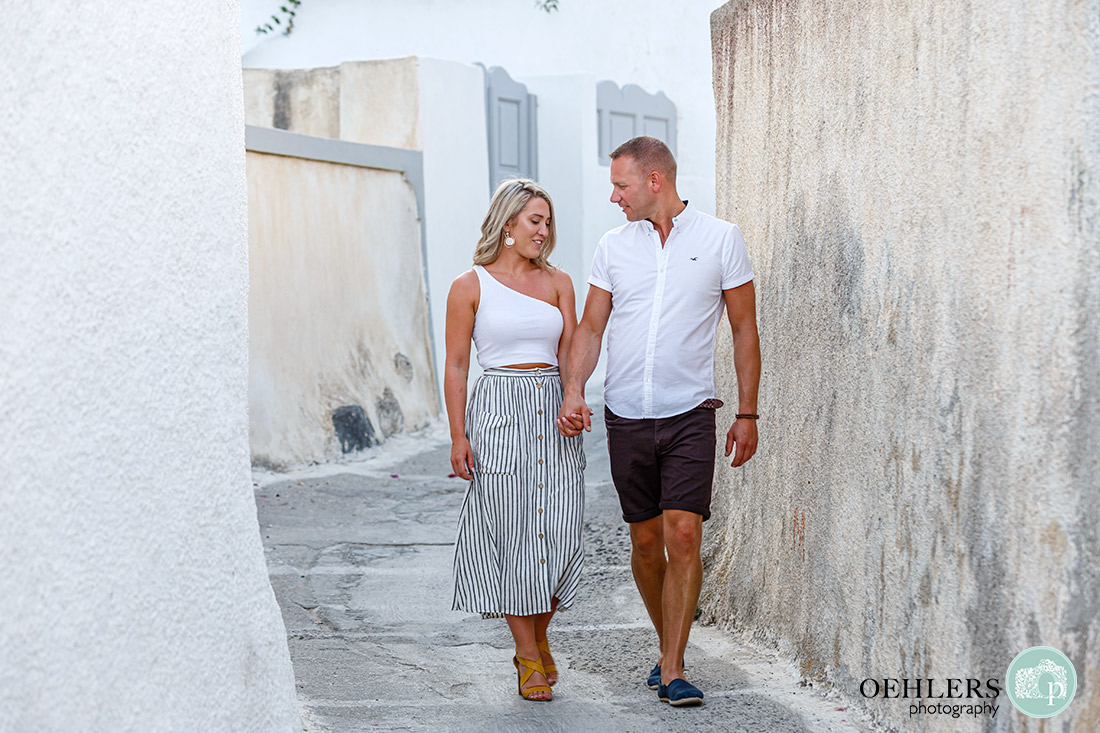 Santorini Wedding Photographers - walking hand in hand through the narrow streets.