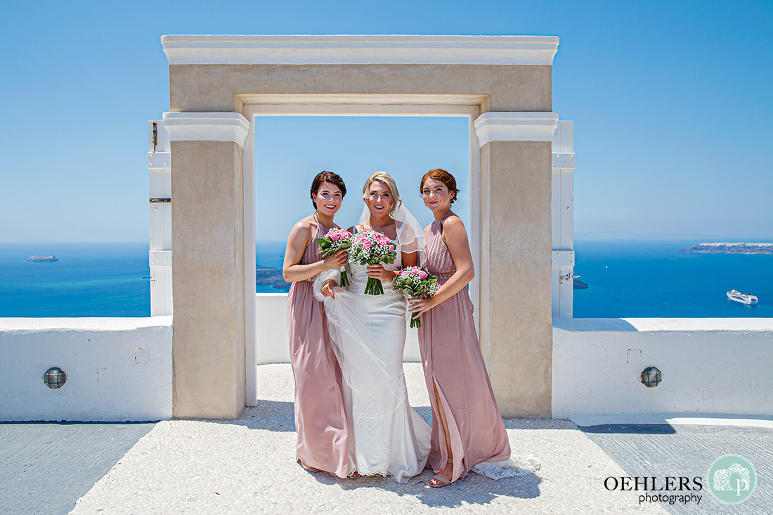 bride with her bridesmaids in front of the entrance to the Santos Winery ceremony area.