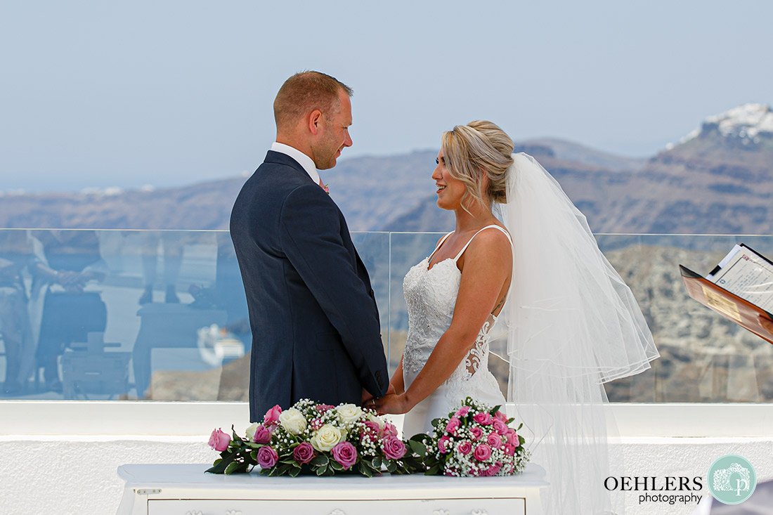 Santorini Destination Wedding Photographers - bride and groom saying their vows.