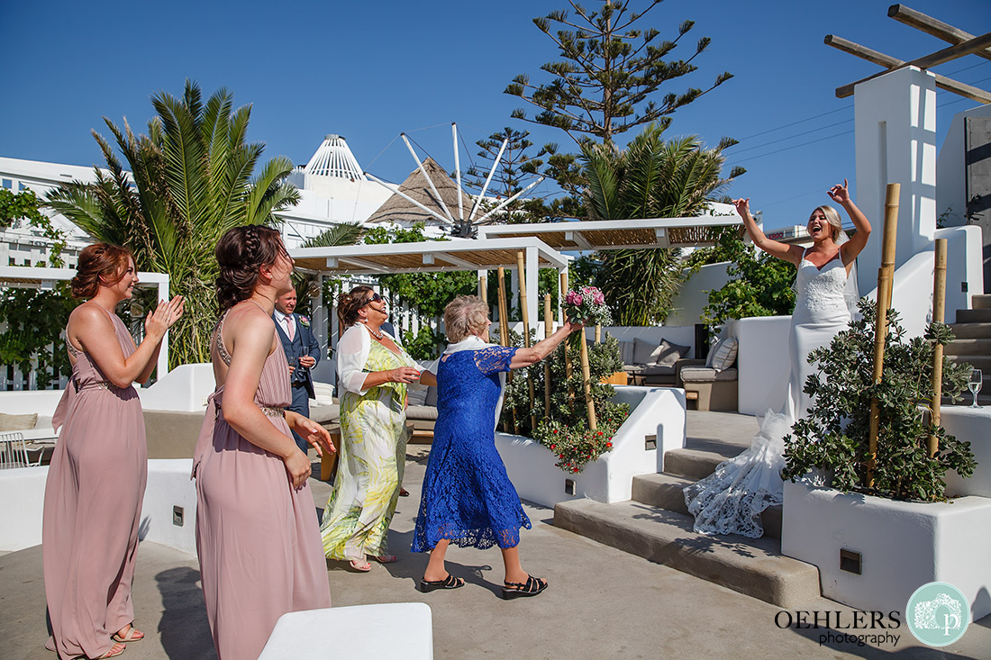 Photograph of the bride's grandmother catching the wedding bouquet.