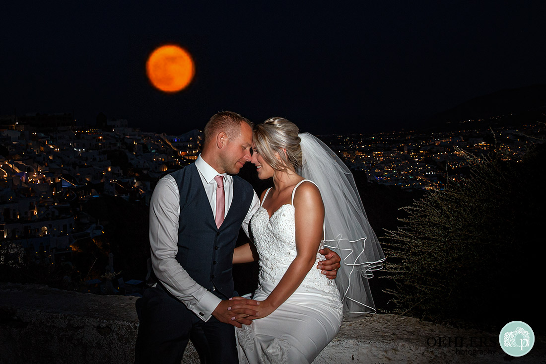 Destination Wedding Photographers - Santorini - An amazing shot of the full moon and santorini town in the background.