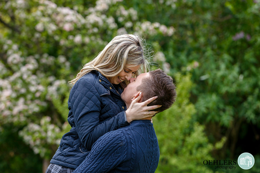 Stoke Rochford Wedding Photographer-Close up of the bride to be being lifted by her fiancé with their noses touching each other.