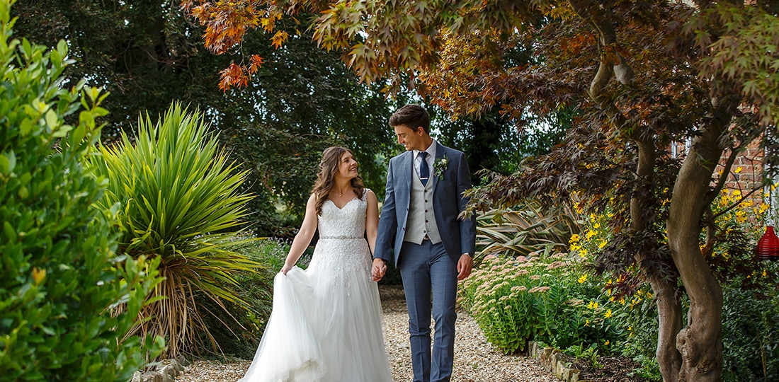 Bride and Groom walking a a pathway