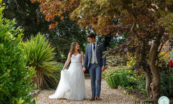 Bride and Groom walking a a pathway