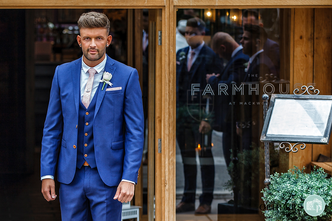 Osmaston Park wedding photography - Groom outside the farmhouse at Mackworth