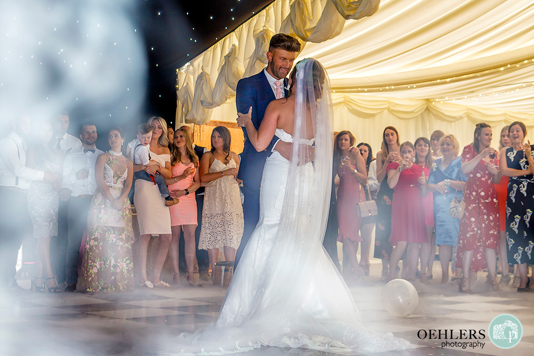 Osmaston Park wedding photography - bride and groom first dance on the smoke filled dance floor