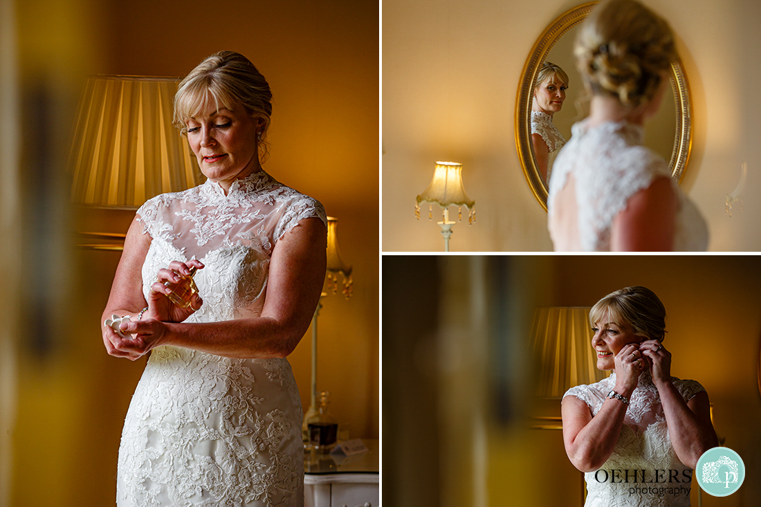 Bride putting on her perfume and earrings