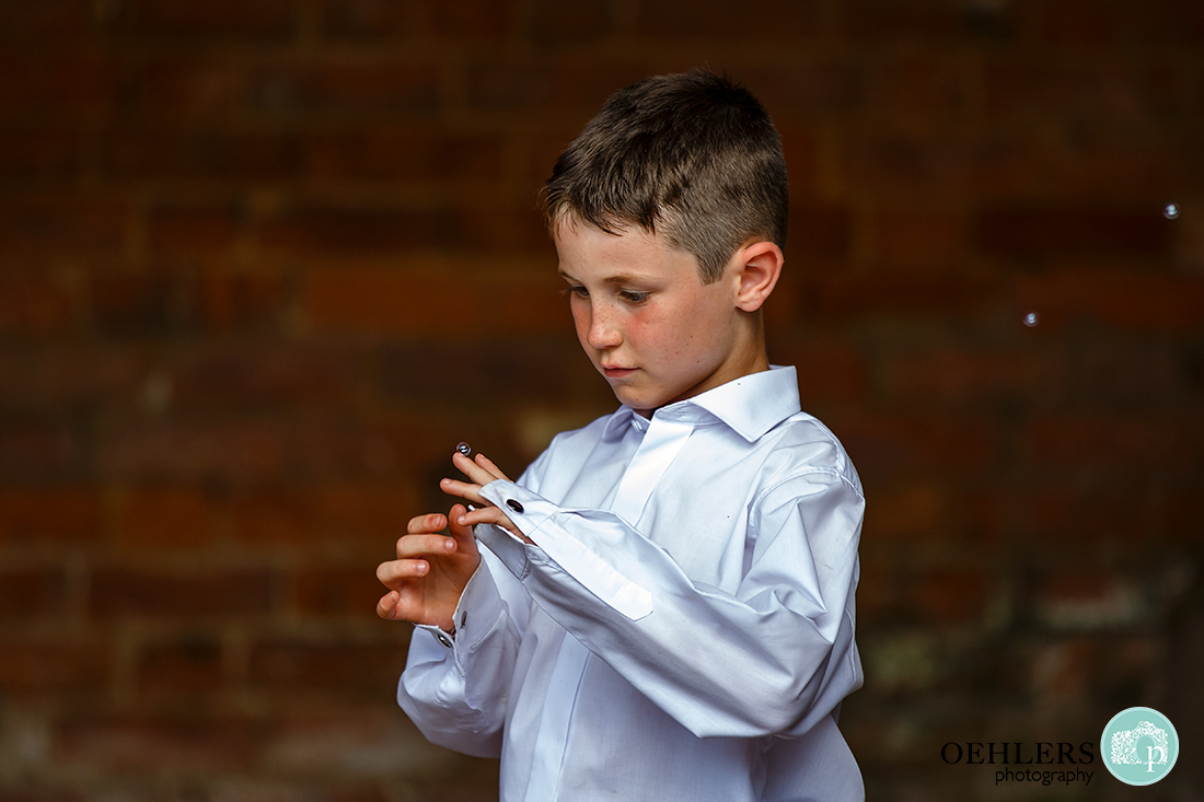 Young lad balancing a small bubble on his middle finger