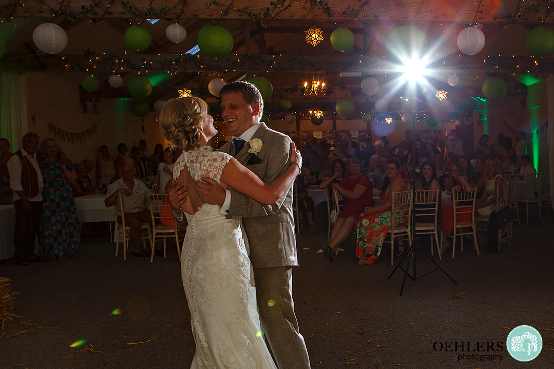 A happy couple first dance with star bursts in the background.