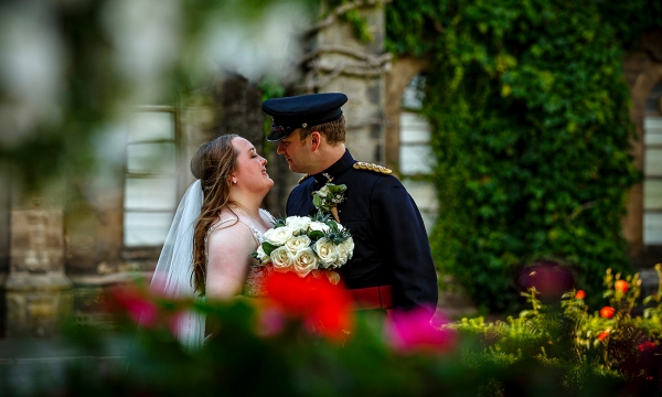 bride looking at her husband dressed in uniform