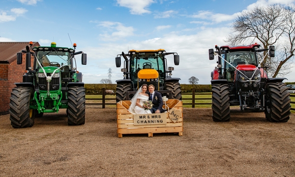 Bride and Groom in a potato crate on a tractor